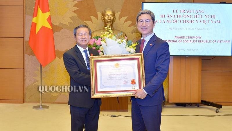 国会副主席杜伯巳向韩越友好议员小组主席金贺勇授予越南的友谊勋章。（图片来源：国会门户网站）